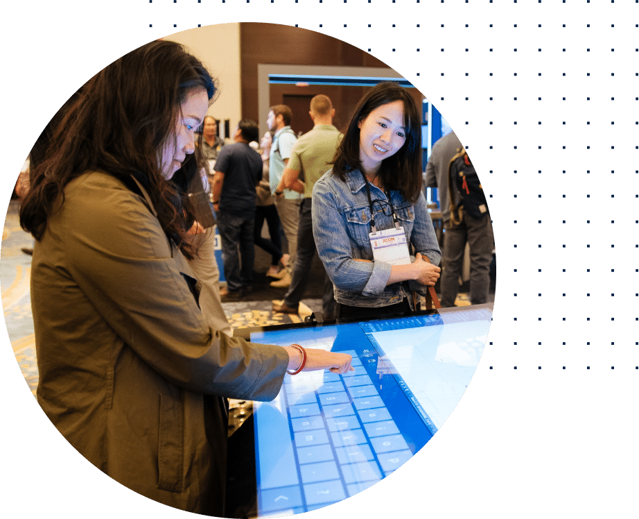 http://Woman%20interacts%20with%20a%20large%20touchscreen%20at%20a%20conference
