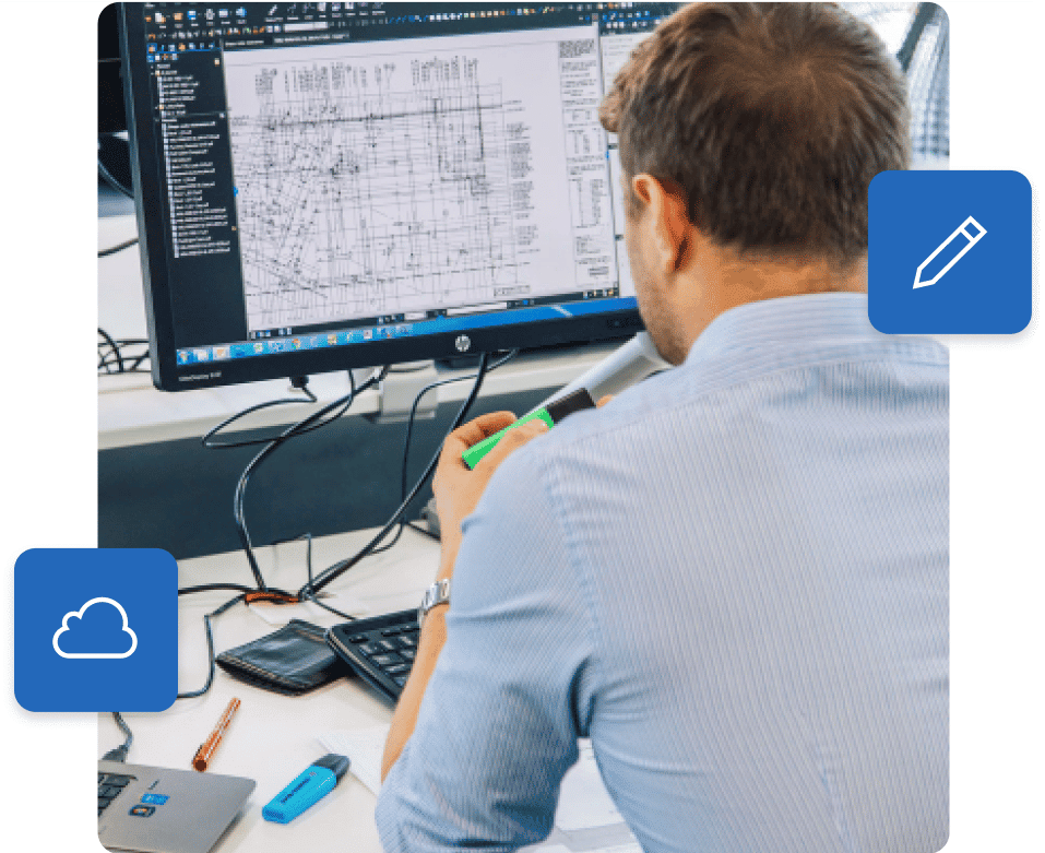 オフィスで Bluebeam 建設ソフトウェアを使用している男性
