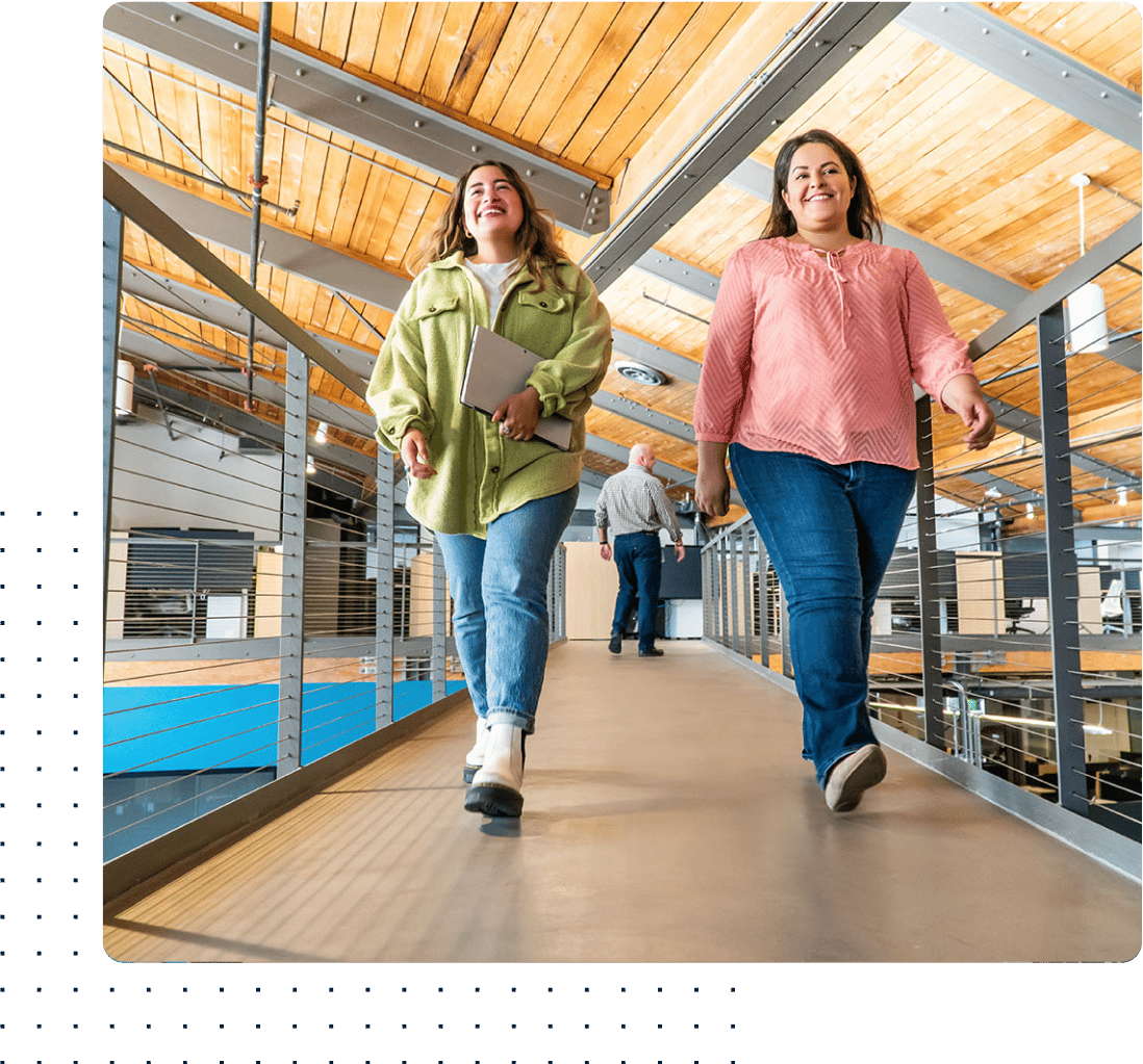 two Women walking and smiling in Bluebeam office