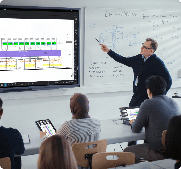Teacher points to a TV screen with Revu in classroom